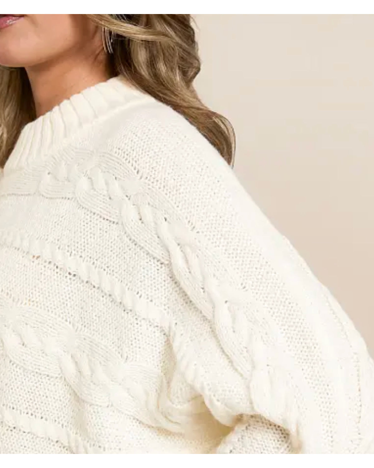 Off-white cable-knit sweater detail with textured horizontal knit rows