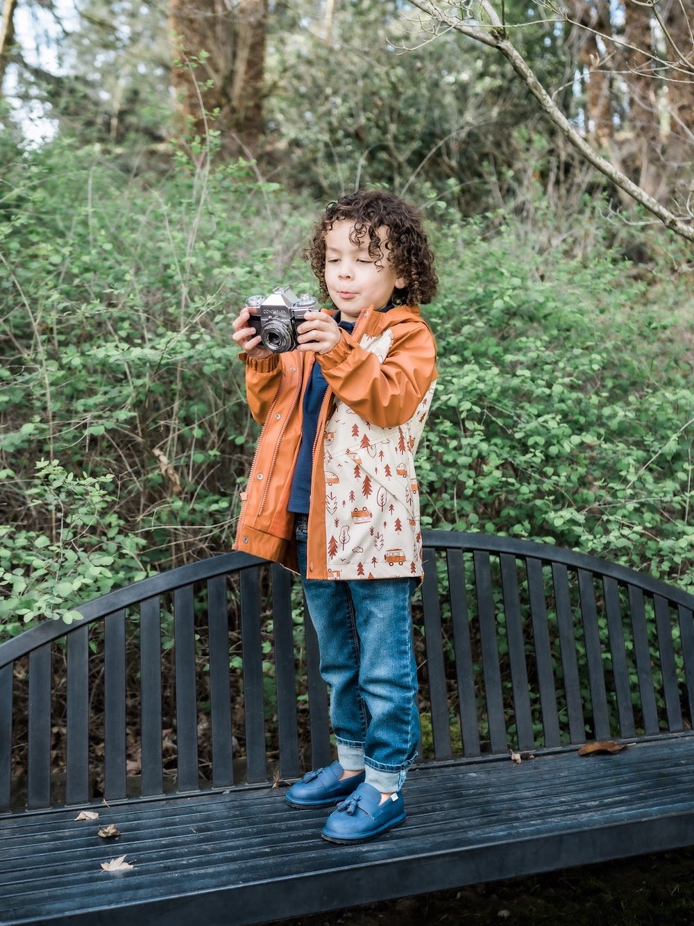 Kids barefoot shoes, blue low-profile slip-on shoes on a child outdoors