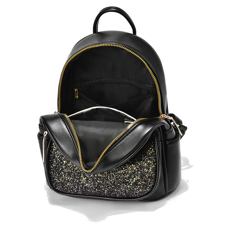Black PU leather backpack with glitter front pocket and yellow zipper trim, top handle.