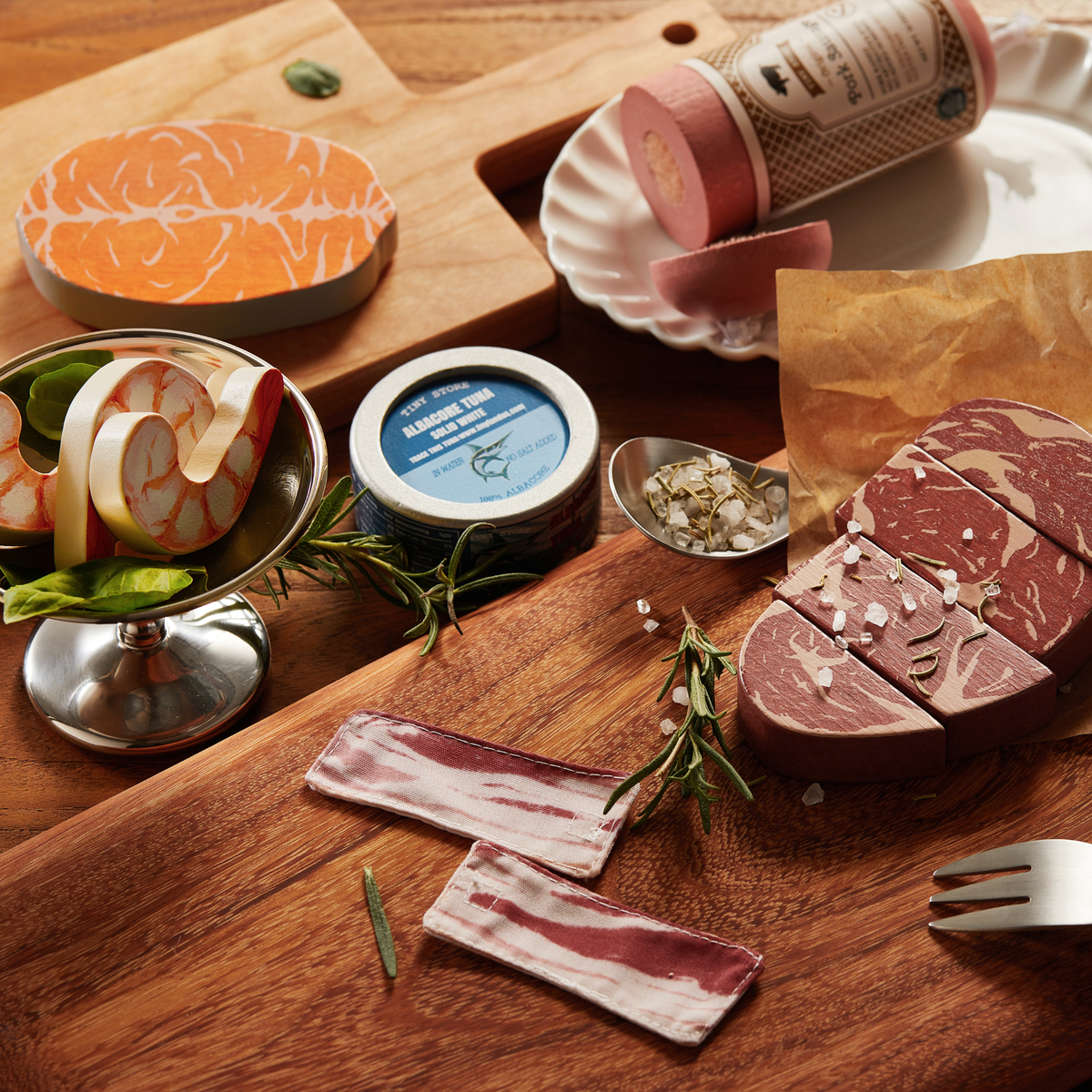 Wooden play food assortment with sliced meat, shrimp pieces, and canned-style tins