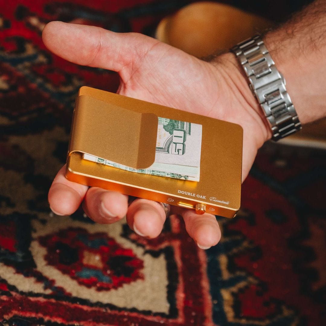 Gold pop-up cardholder open, showing card slots and a cash clip.