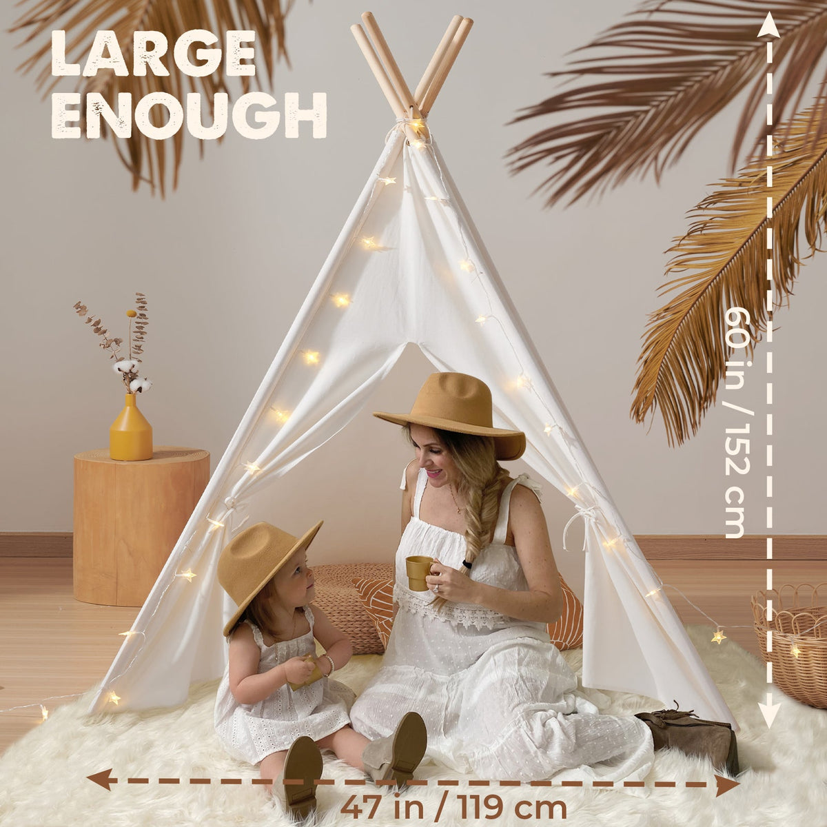 Kids teepee tent with floor mat, white canvas with string lights and children inside