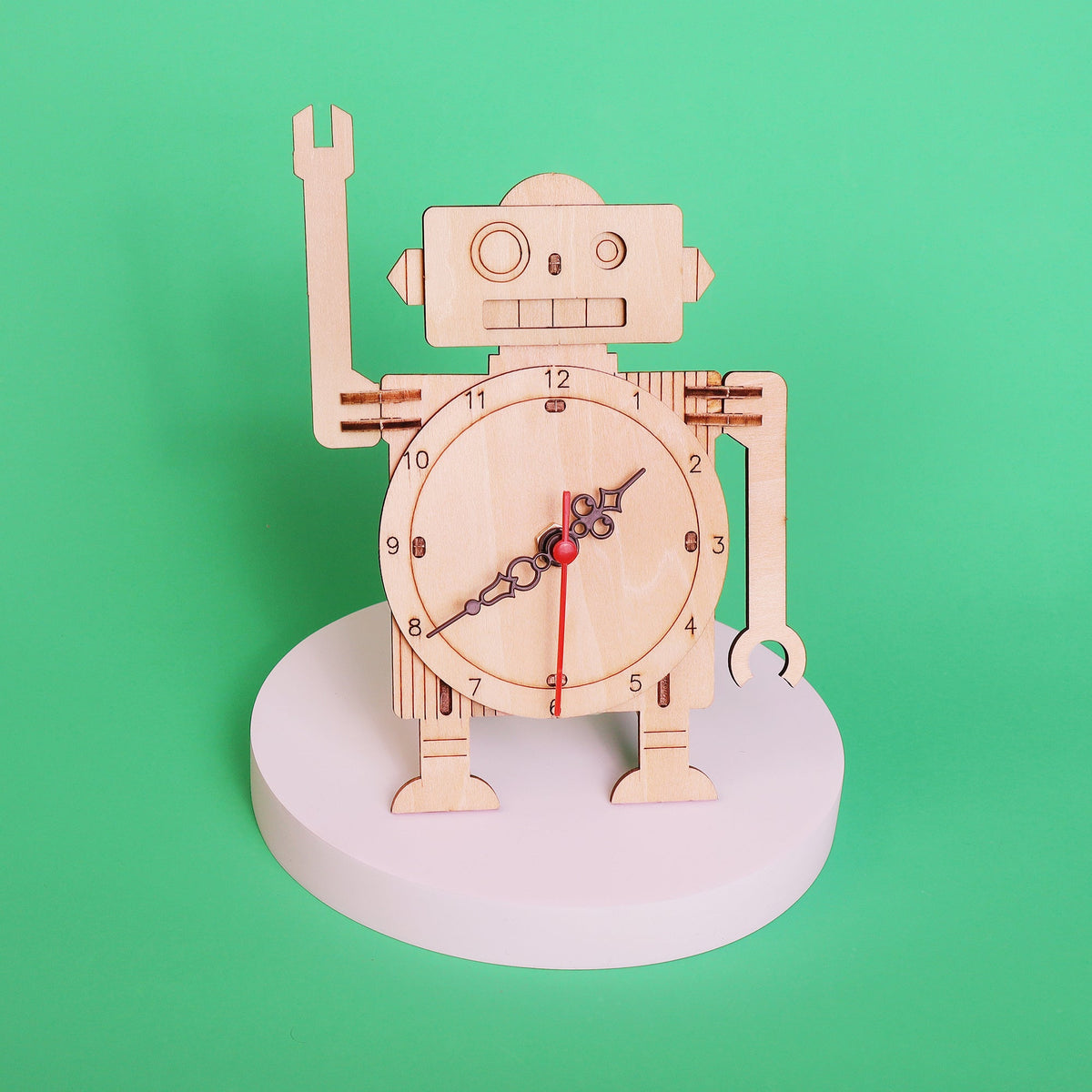 Wooden robot clock DIY kit on circular base, front-facing clock dial with red hand