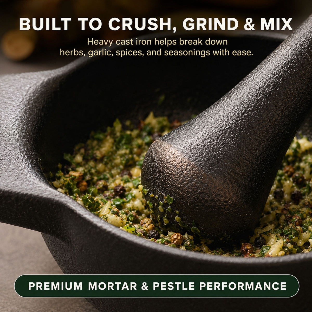 Black cast iron mortar with pestle crushing herb mixture