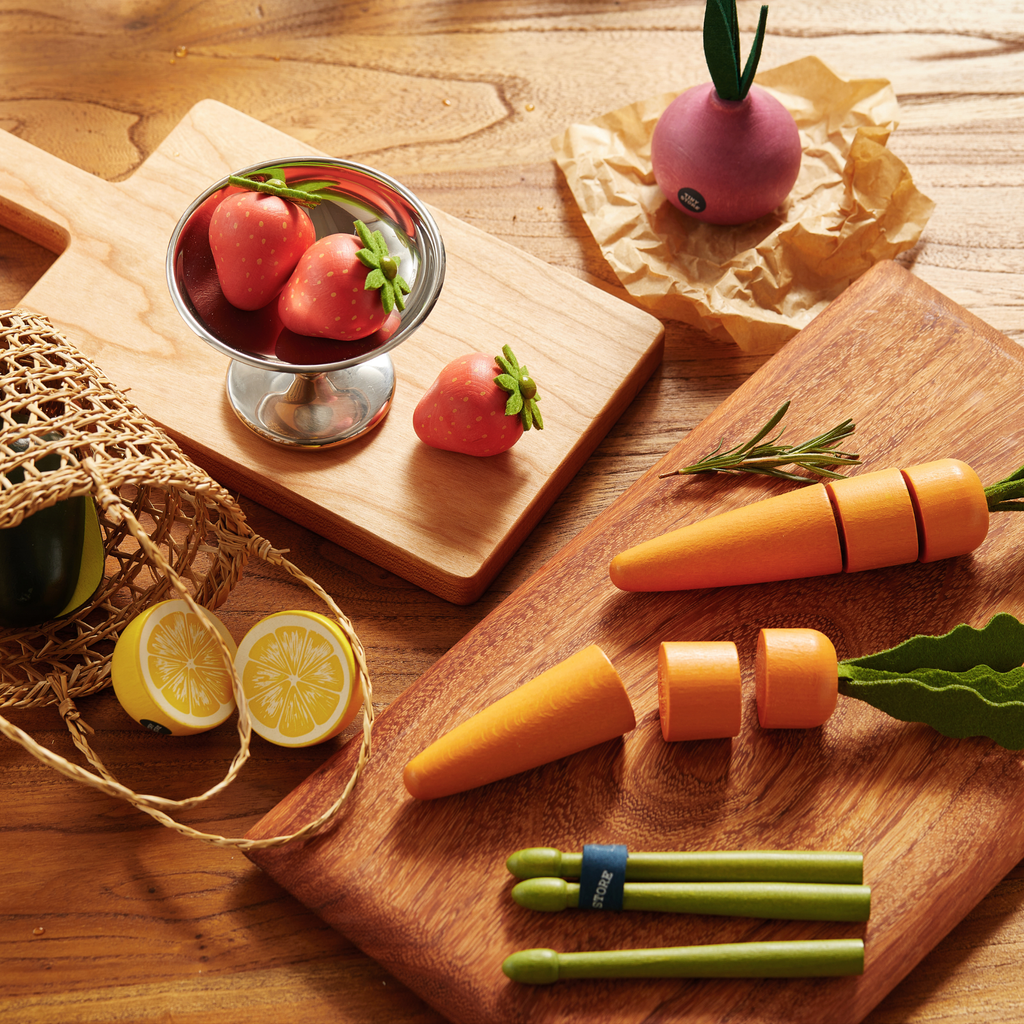 Toy fruit and veggie set with carrot, strawberries, peas, and avocado pieces