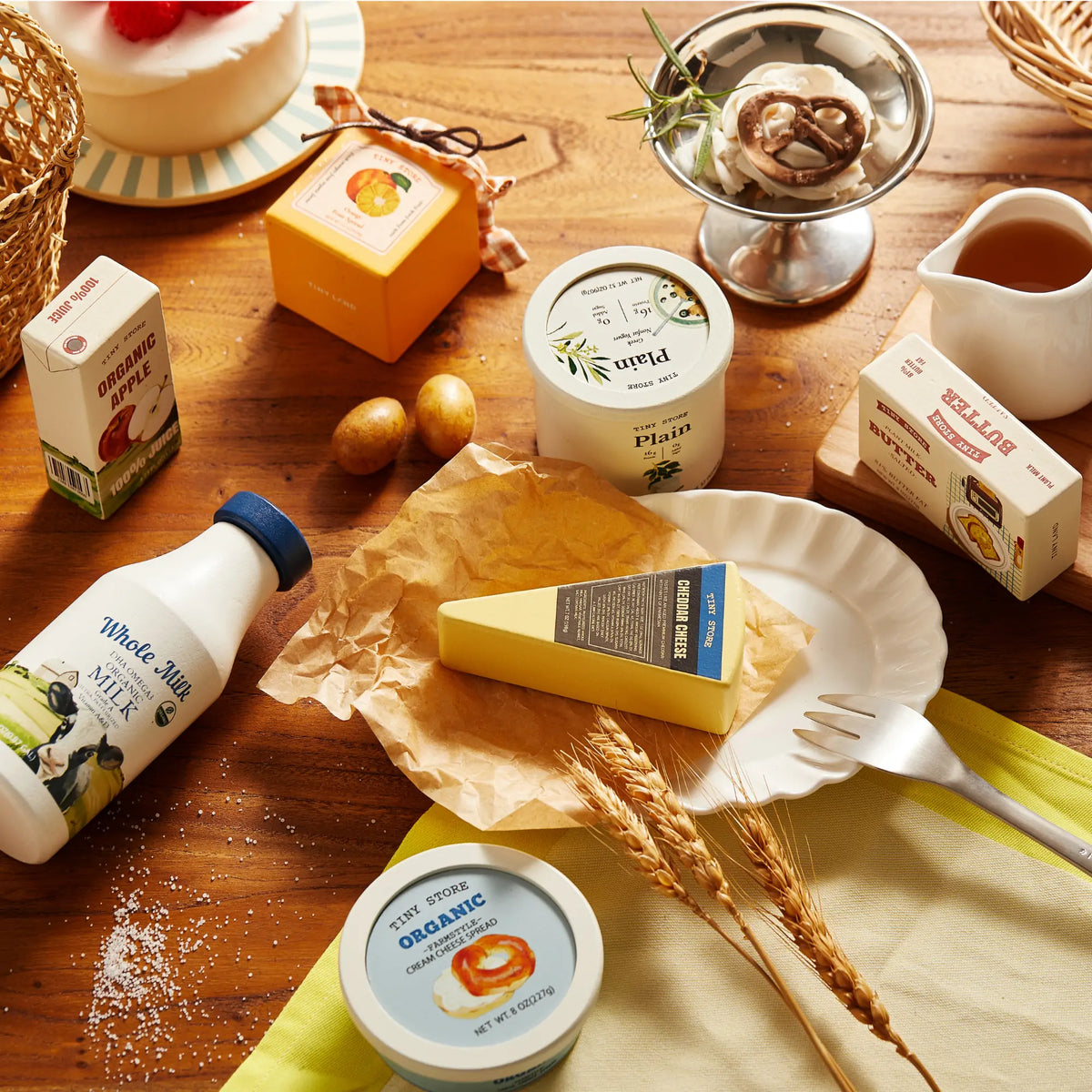 Pretend dairy play food on plate: milk bottle, cheese block, butter, and cheese spread tub