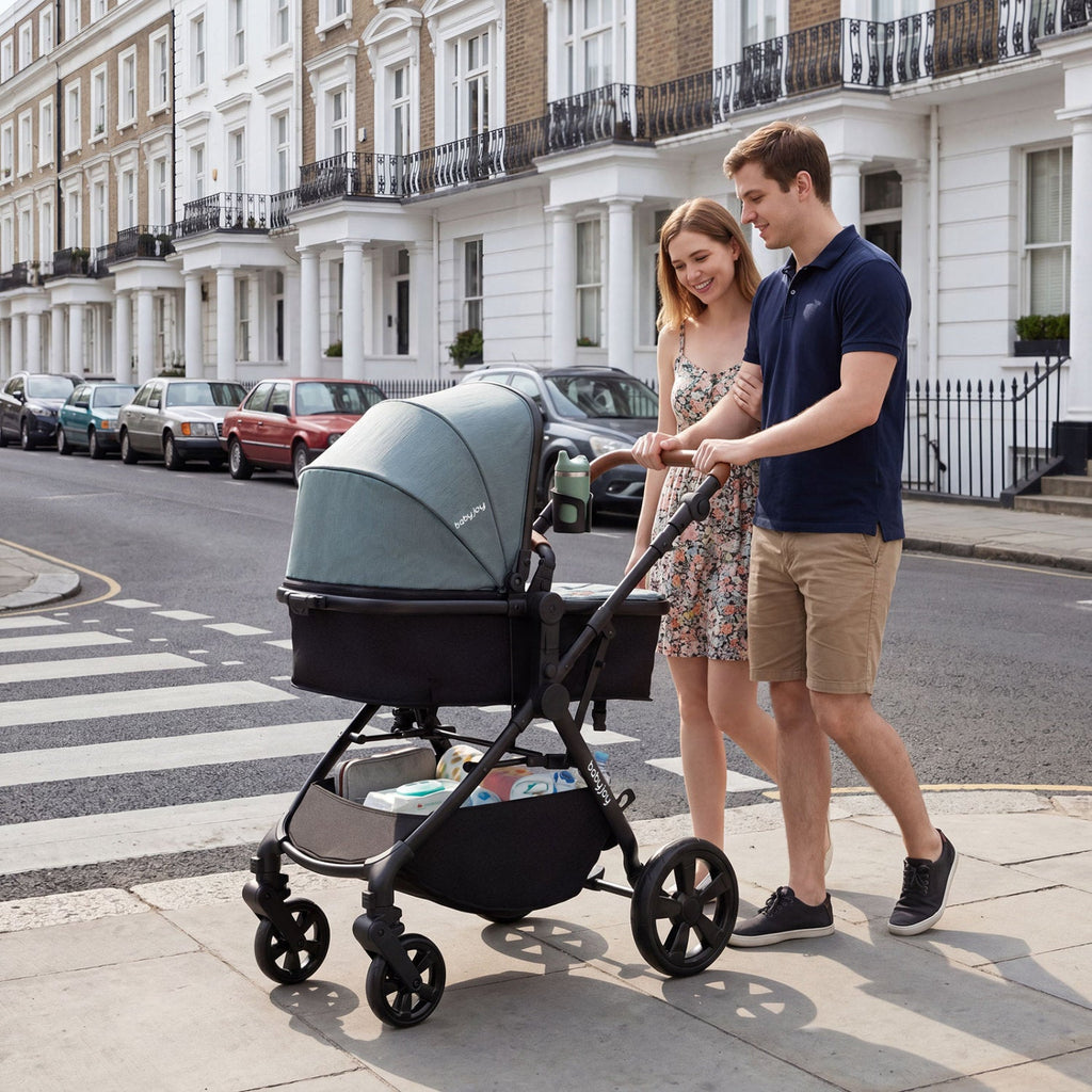 Gray convertible baby stroller with black seat and canopy, set up on city sidewalk