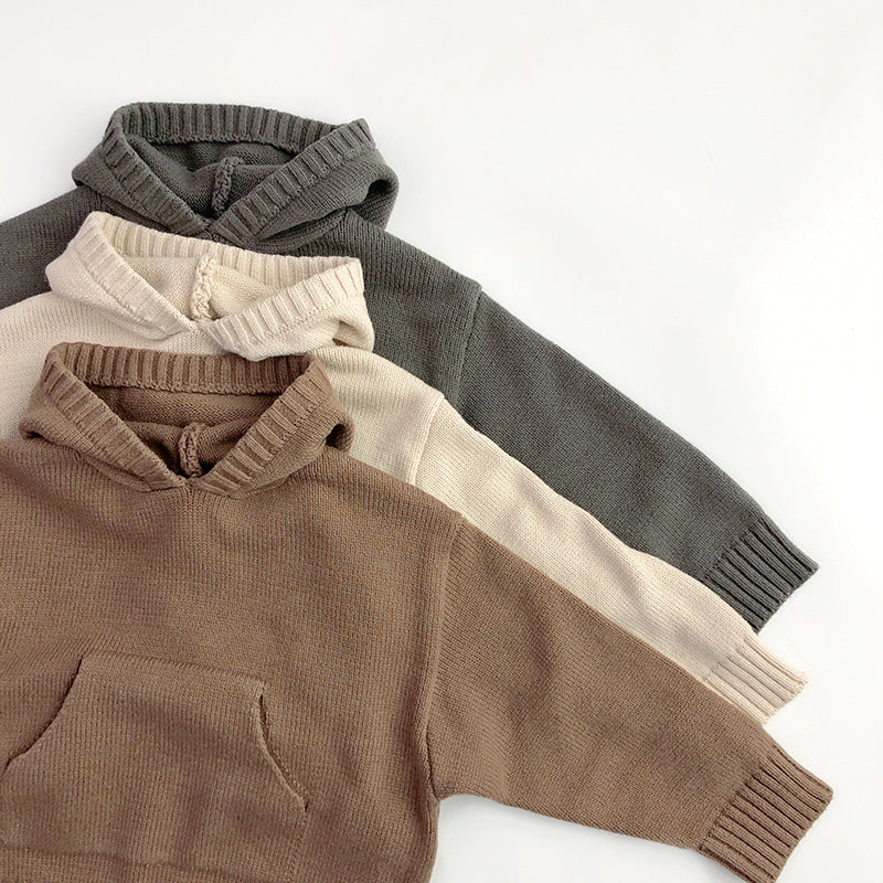 Children's hoodies stacked: brown, cream, light gray, and dark gray with ribbed cuffs