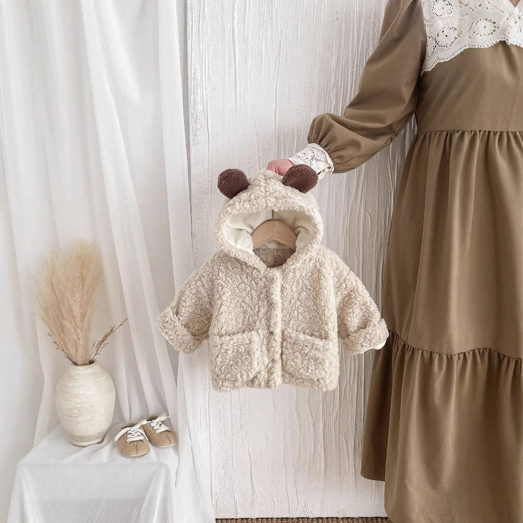 Cream plush toddler coat with bear-ear hood and brown button accents