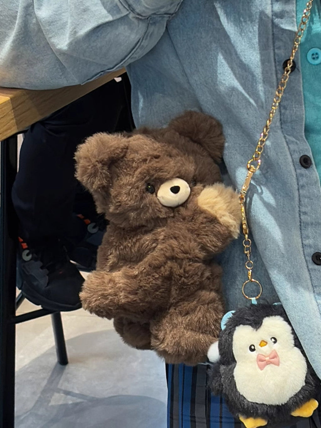 Brown plush teddy bear backpack bag with front teddy face and a small bear charm