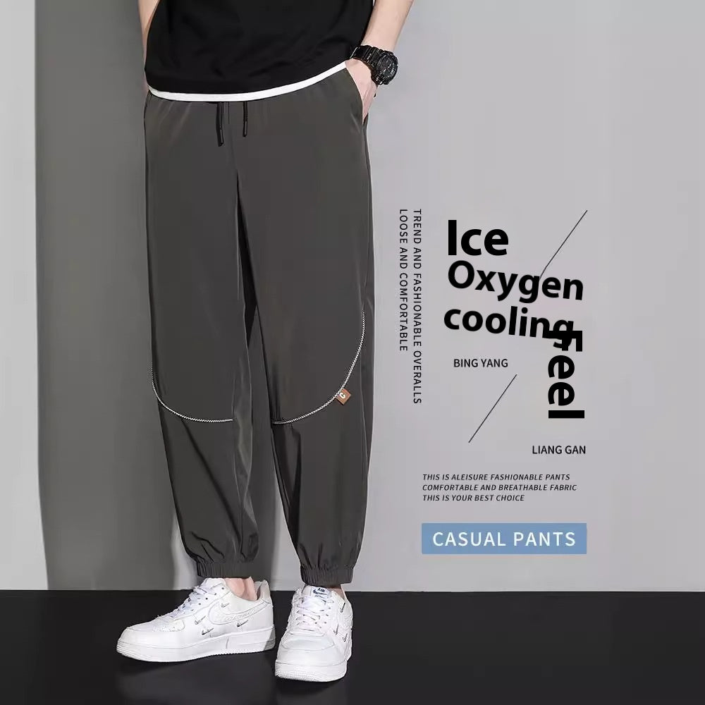 Men's tapered casual pants in black, drawstring waist, cuffed ankle hems