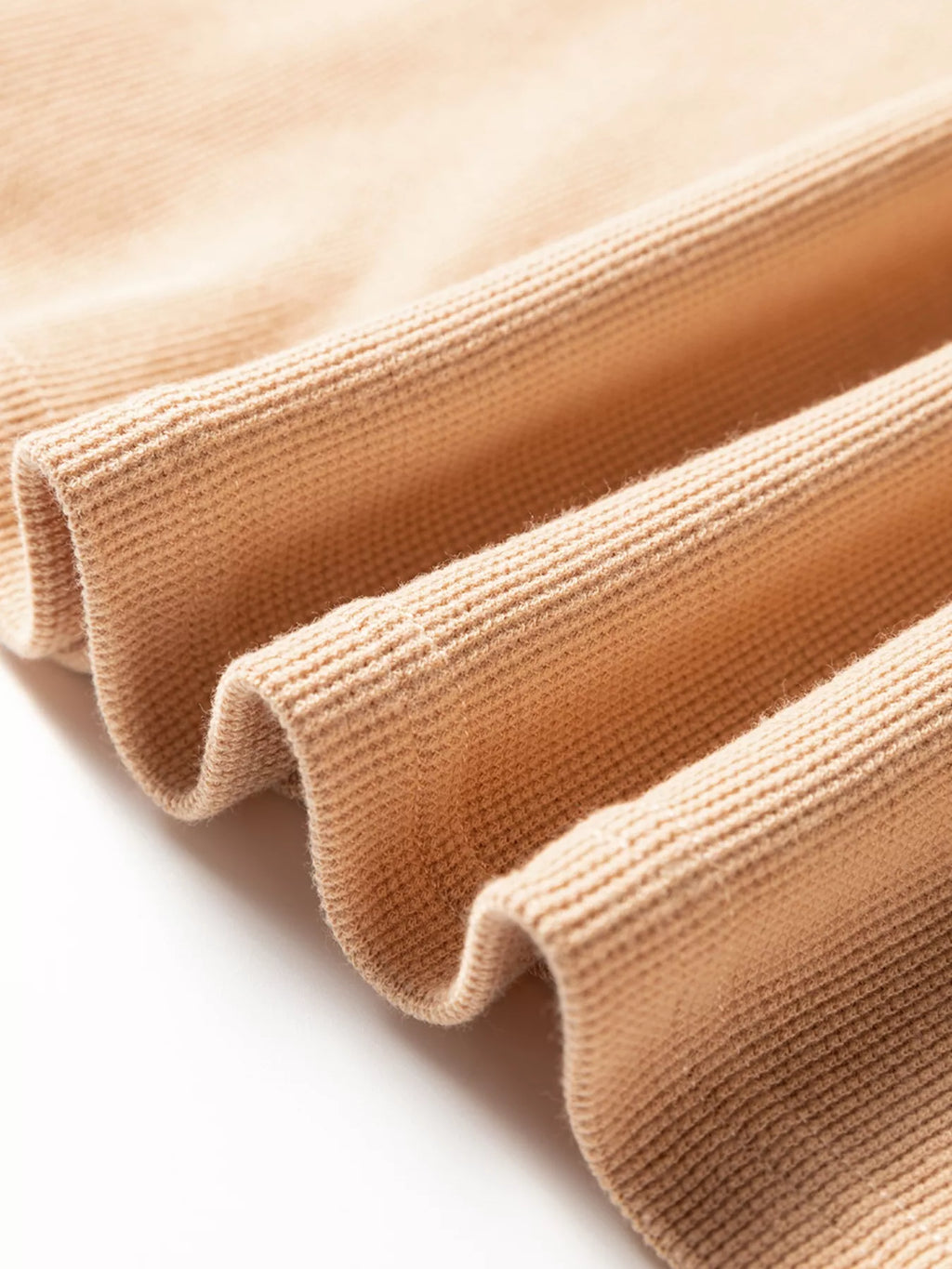 Camel thermal knit henley top, ribbed hem and sleeve cuff texture close-up