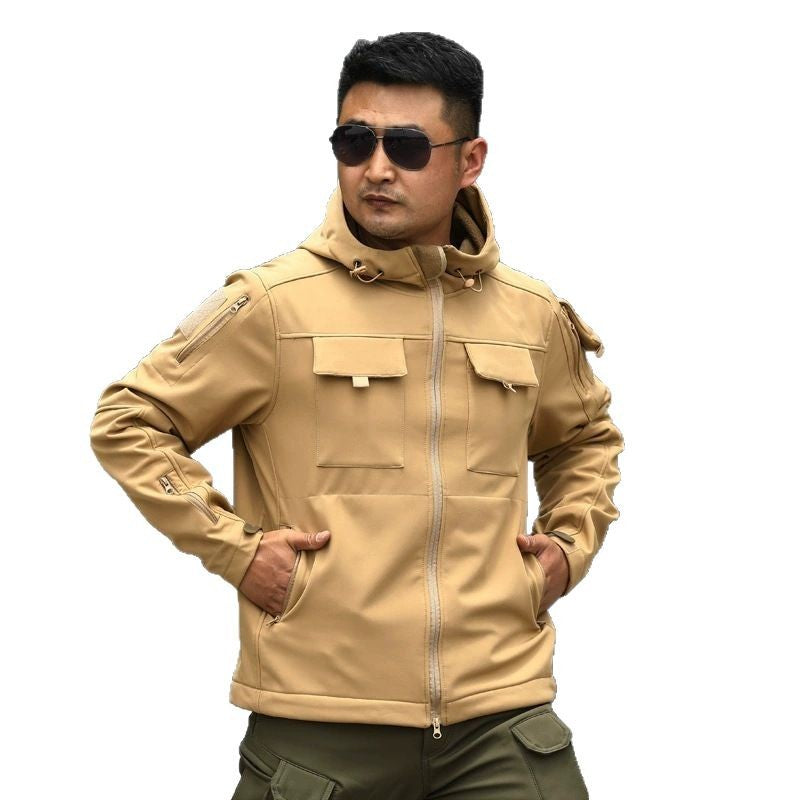 Khaki tactical shell jacket with stand collar, zip-front, and flap chest pockets.