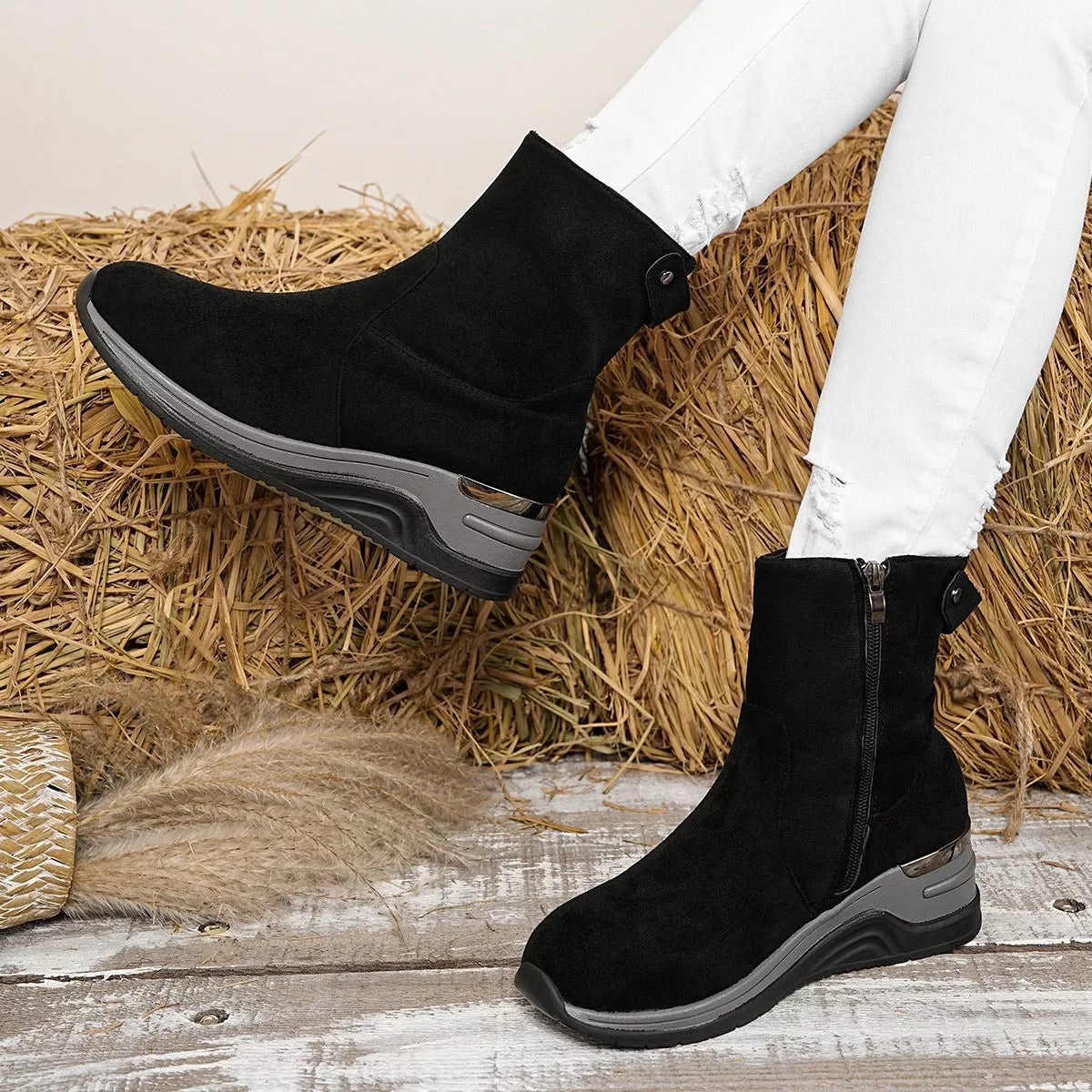 Black suede ankle boots with wedge heel, side zipper and metallic accent plate