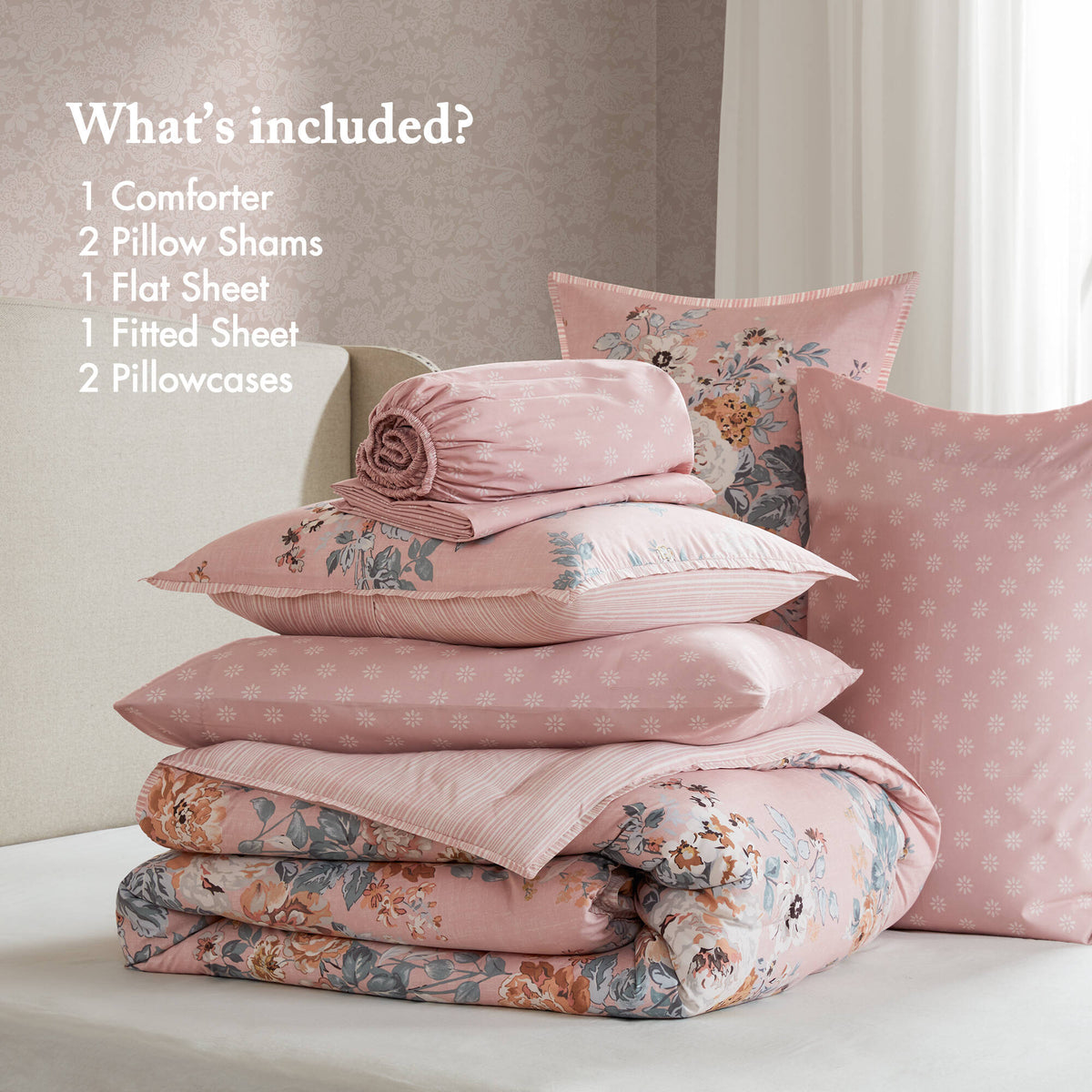 Pink floral bedding set with coordinating pillows and stacked comforter