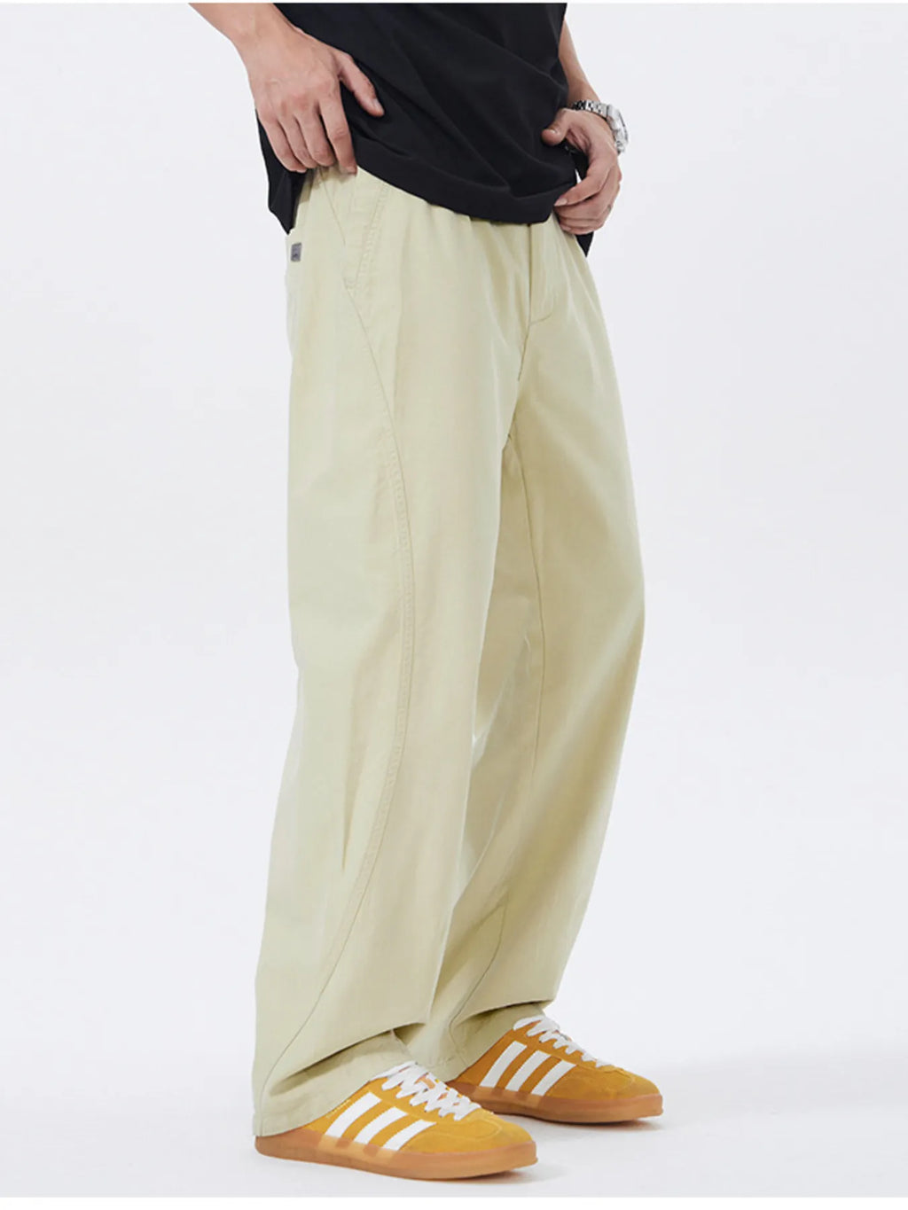 Light khaki loose-fit casual pants, draped legs with cuffed hem and side pockets