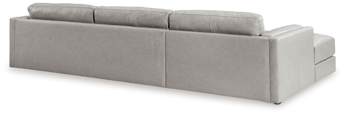 Light gray upholstered sectional sofa with chaise extension and back cushions