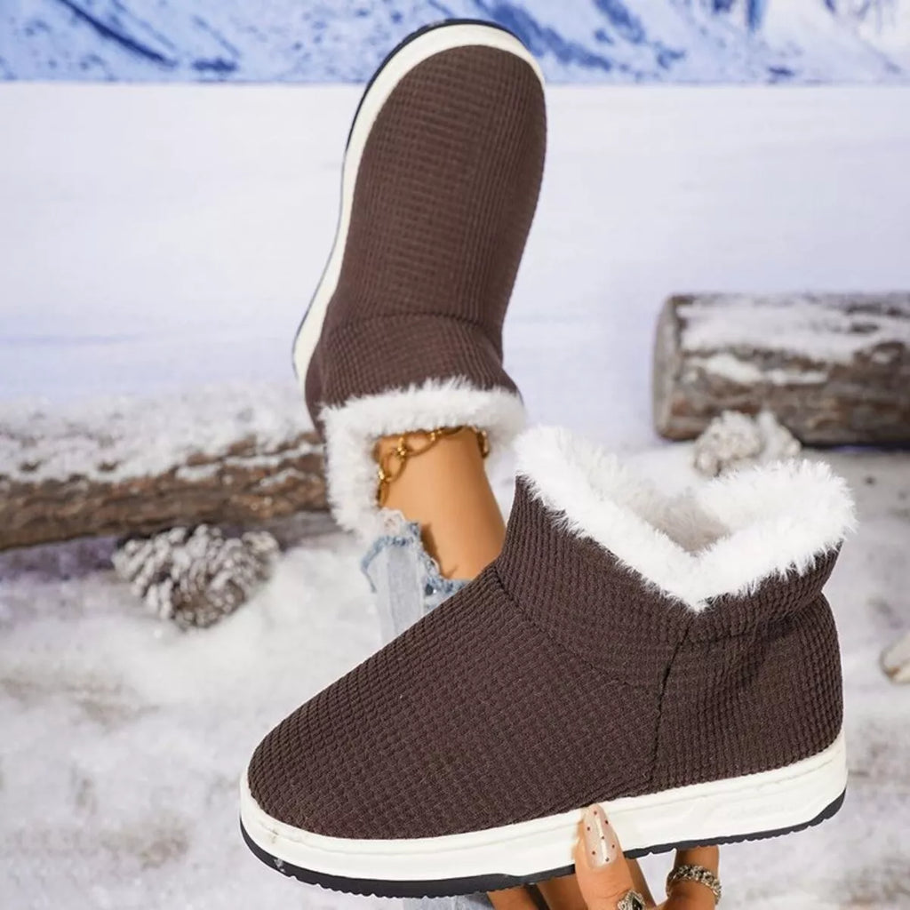 Chocolate brown knit ankle boots with plush white lining and low rubber sole