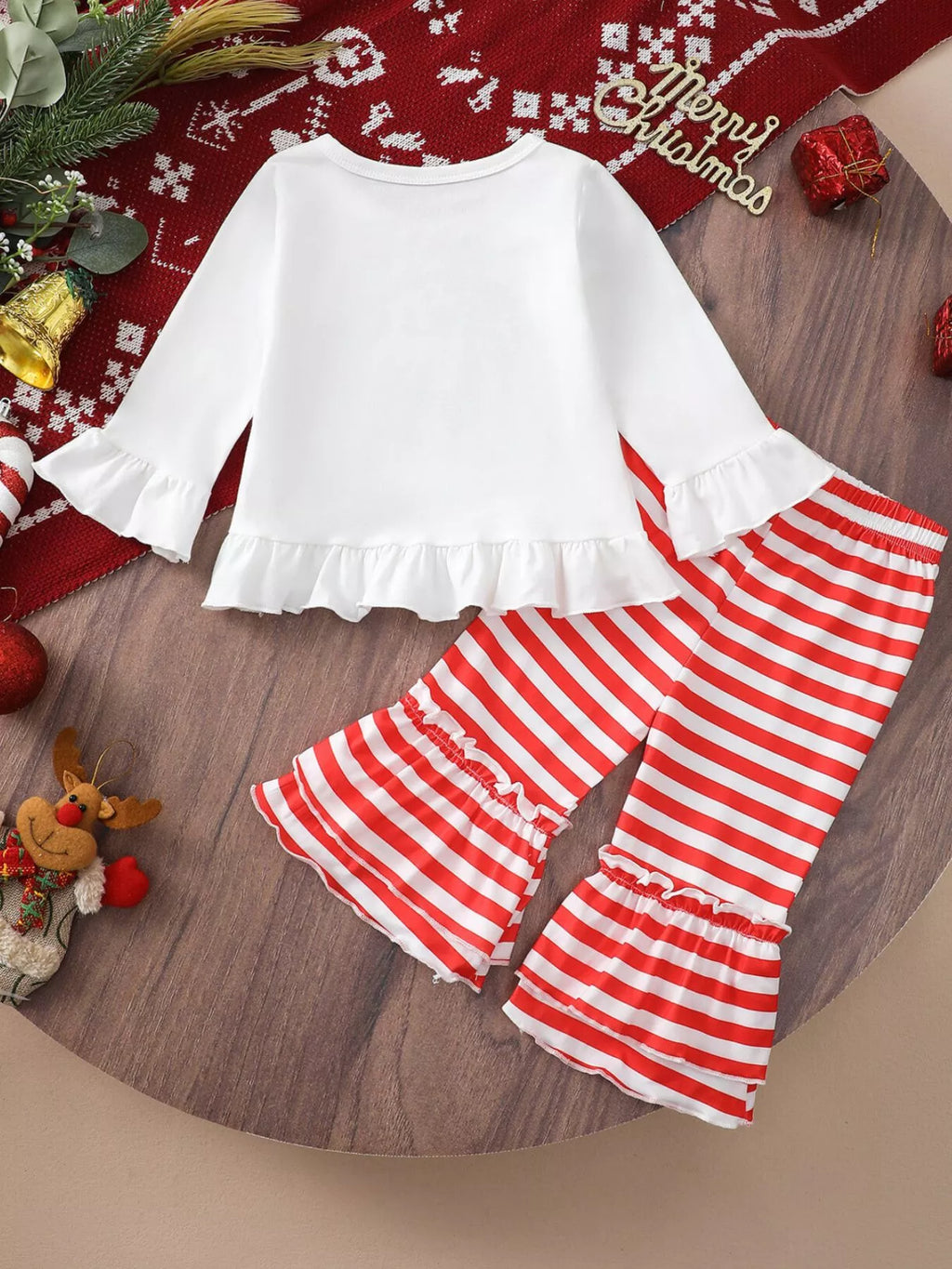White ruffle-hem Christmas top with long bell sleeves and red-and-white striped pants