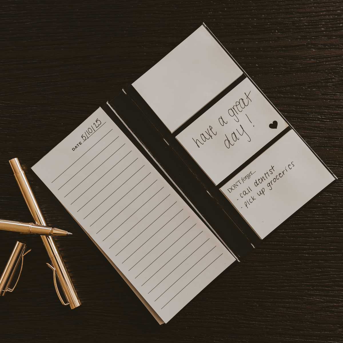 Open sticky notes booklet with lined page and sticky tabs with “have a great day” text.