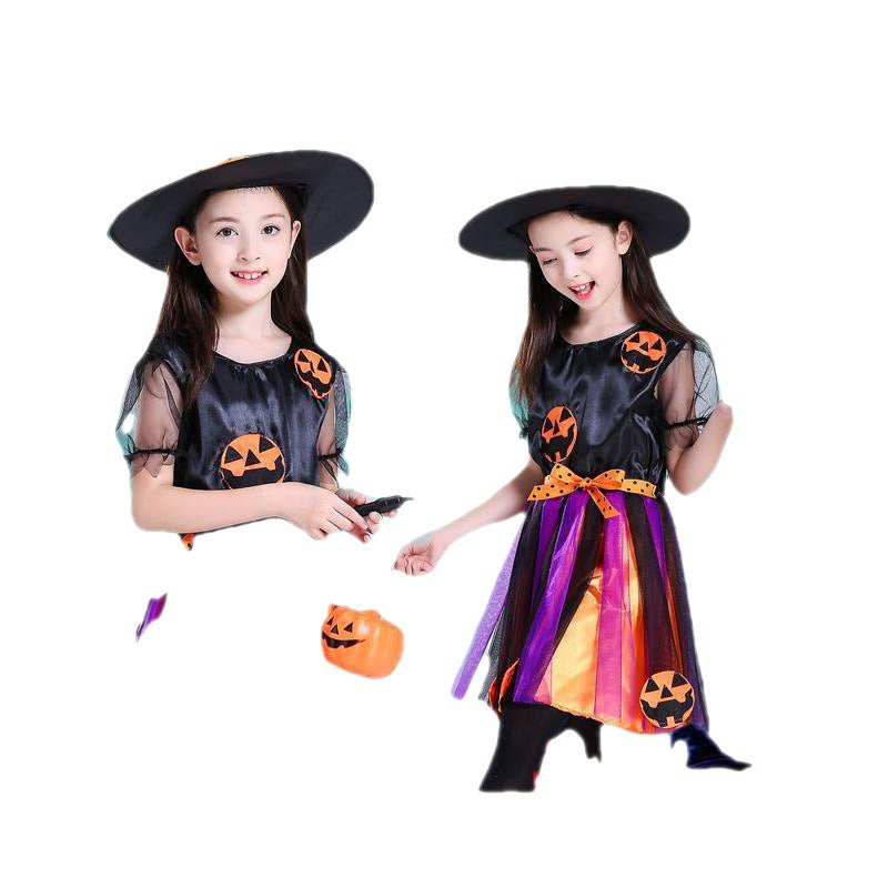 Children's witch costume: black hat, sheer-sleeve top, rainbow striped skirt, holding jack-o-lantern