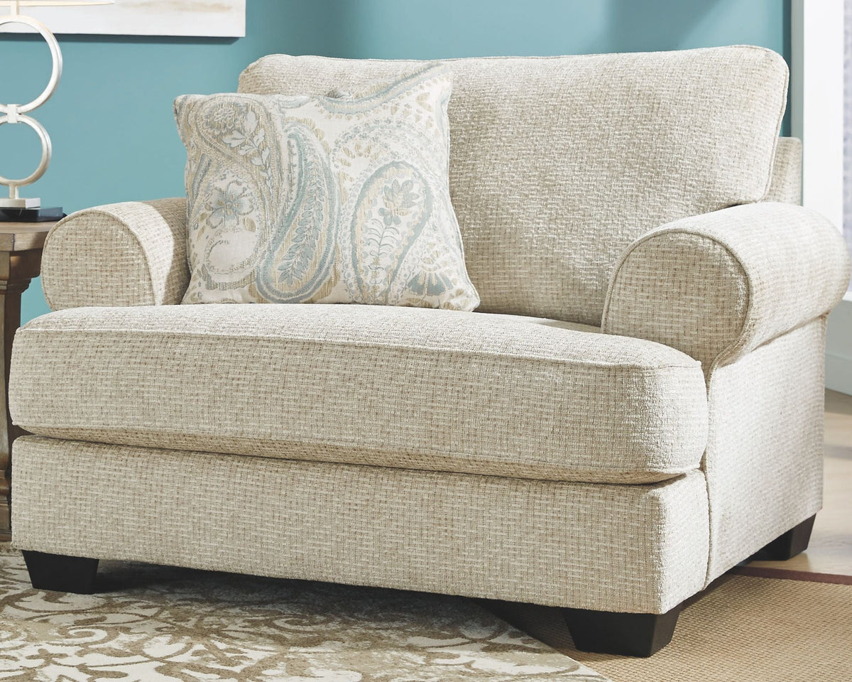 Sandstone upholstered chair with patterned lumbar pillow, wide seat, dark legs