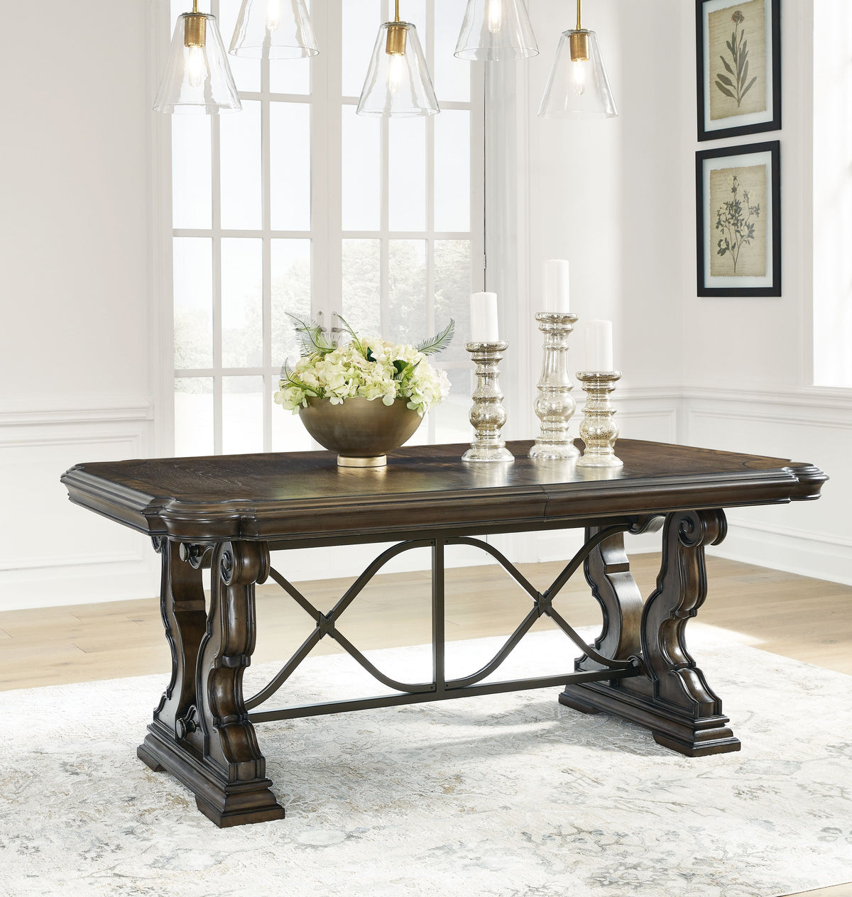 Dark brown dining extension table with X-base and decorative wood carvings