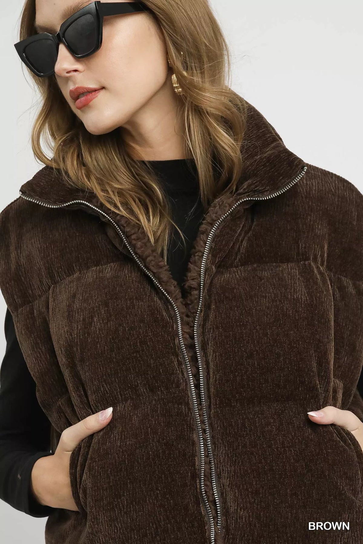 Brown sherpa-lined zip vest detail, high collar and silver zipper trim