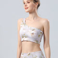 White floral one-shoulder sports bra with matching cropped yoga shorts, side view