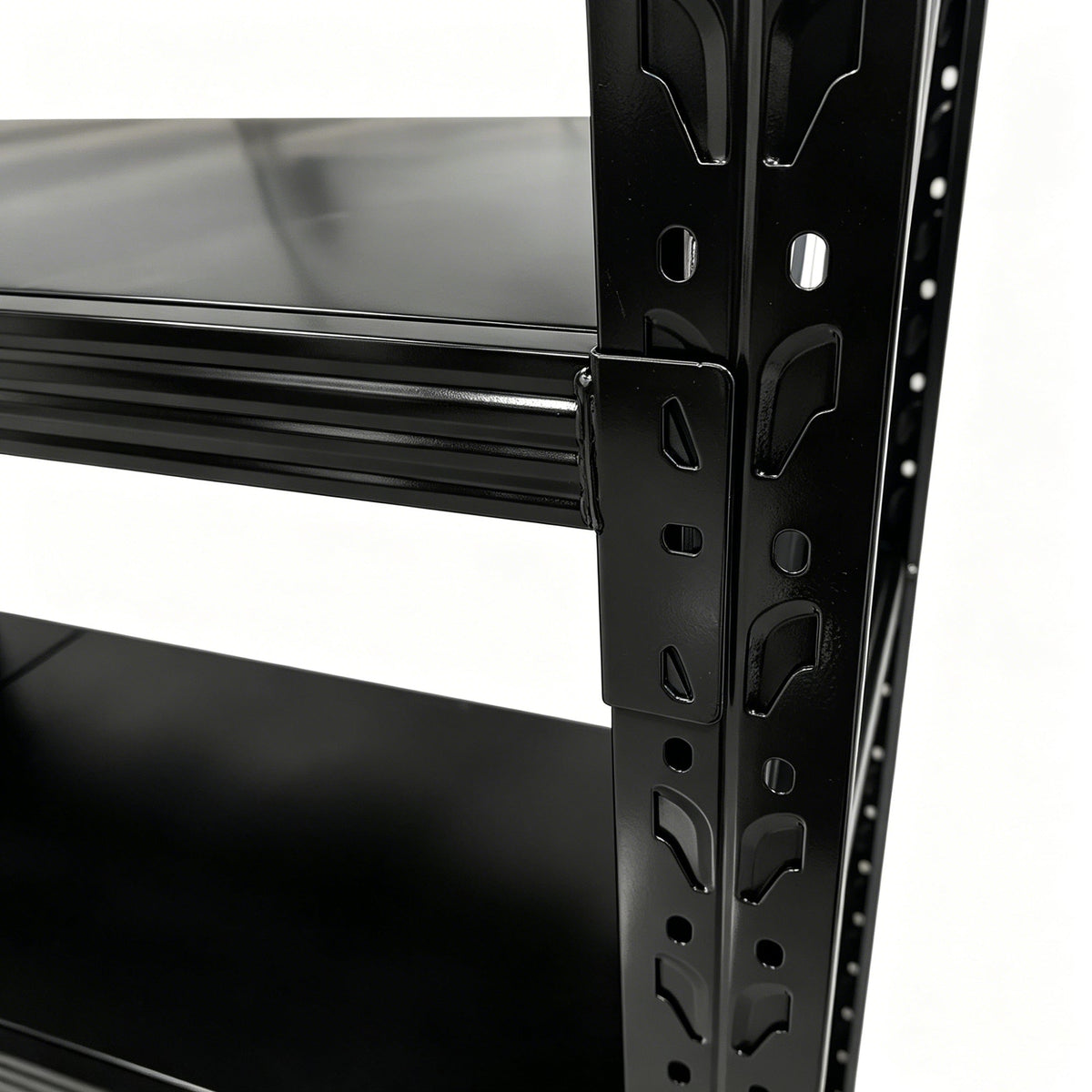 Close-up of a black metal shelf beam connecting to a perforated upright with locking tabs