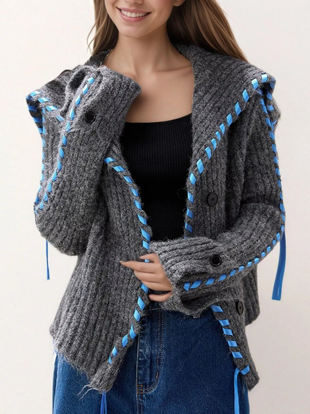 Gray ribbed knit open-front cardigan with blue trim, two front buttons, and cuff ties