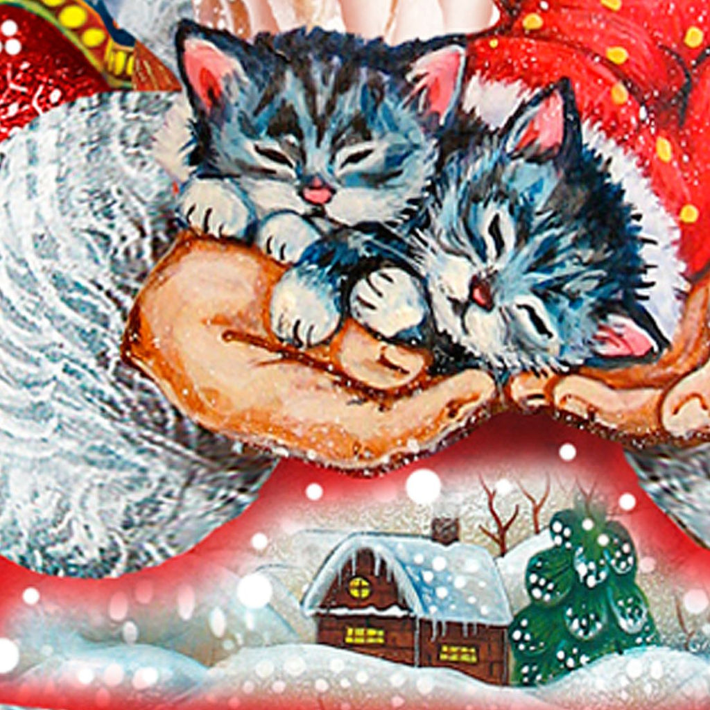 Close-up of Santa holding a blue-gray kitten on an outdoor yard sign cutout