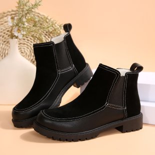 Black platform ankle boots with low heel, pull-on sides, and stitched panels