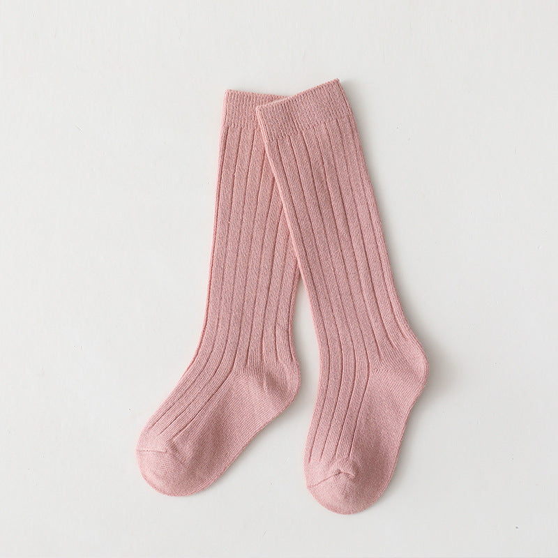 Pair of pink mid-calf ribbed baby socks.