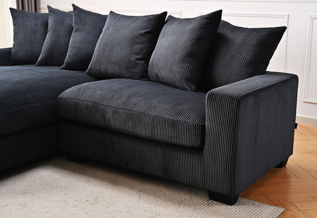 Dark gray L-shaped sectional sofa with chaise and striped upholstery with back pillows.