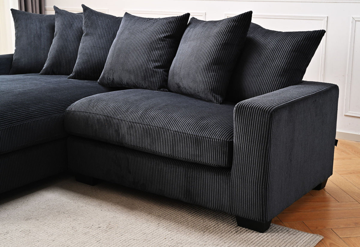 Dark gray L-shaped sectional sofa with chaise and striped upholstery with back pillows.