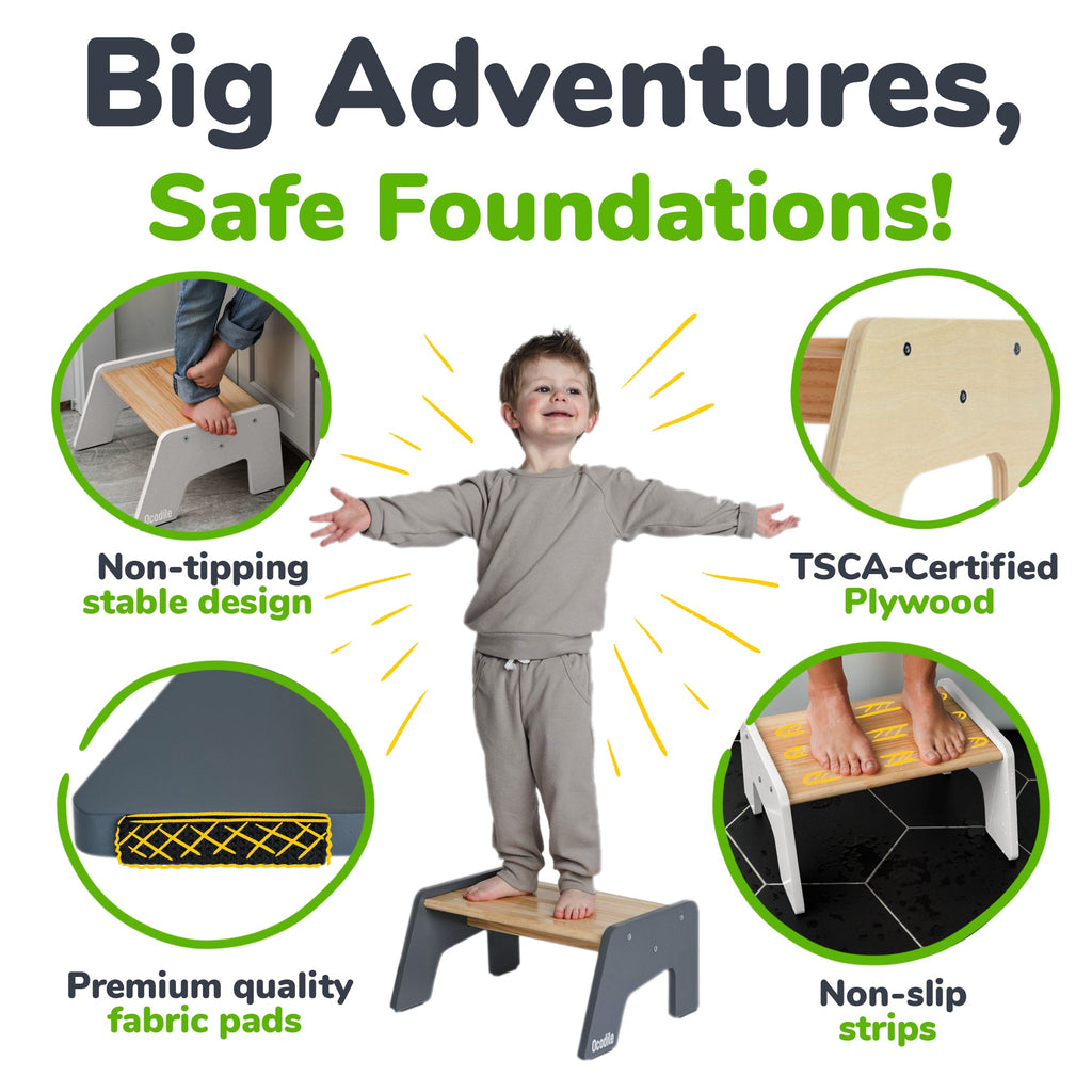 Gray kid step stool with child standing, showing non-slip fabric pads and strips