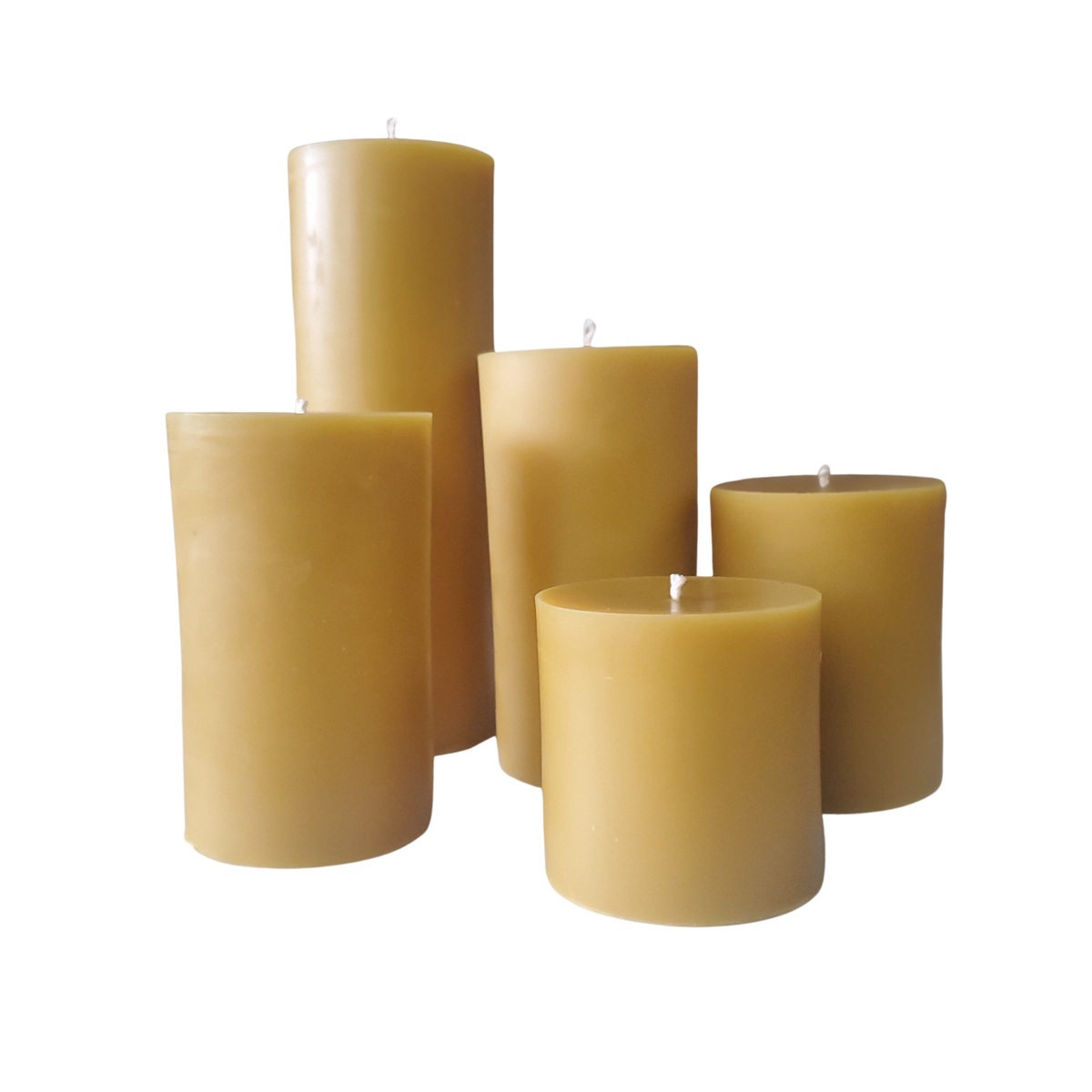 Set of yellow beeswax pillar candles with exposed wicks, various heights