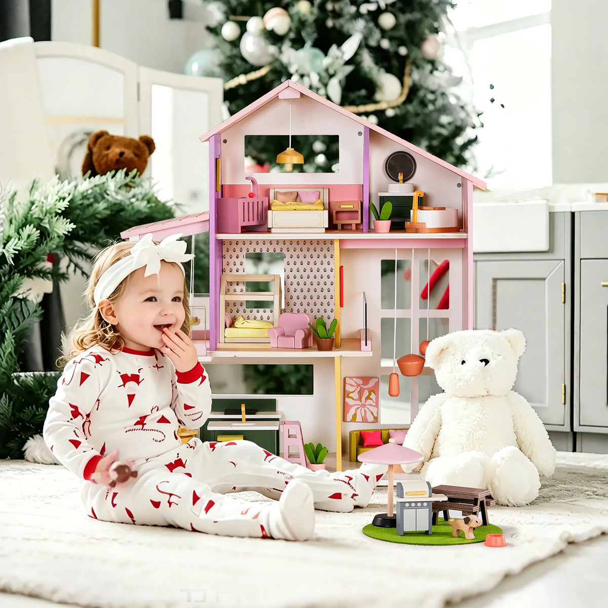 Pink dollhouse with mini furniture and accessories, front open room