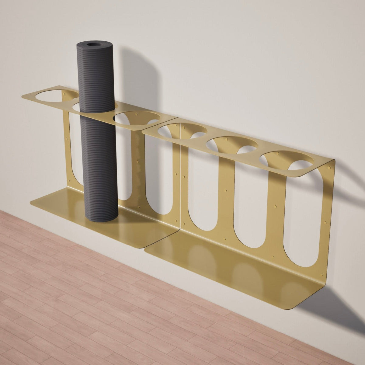 Gold yoga mat rack holding three rolled yoga mats