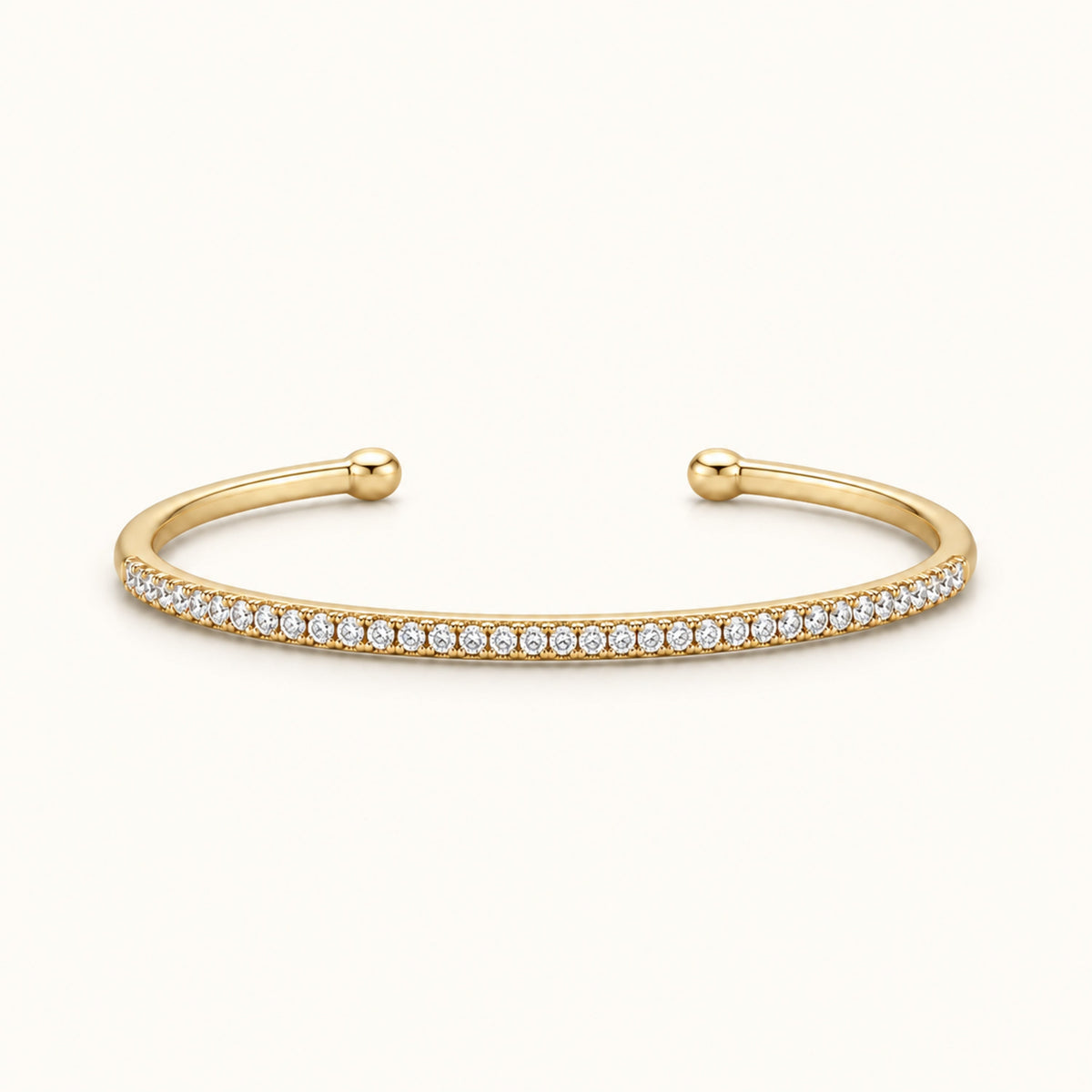 Thin gold-tone pave cuff bracelet with small round stones, hinged open ends