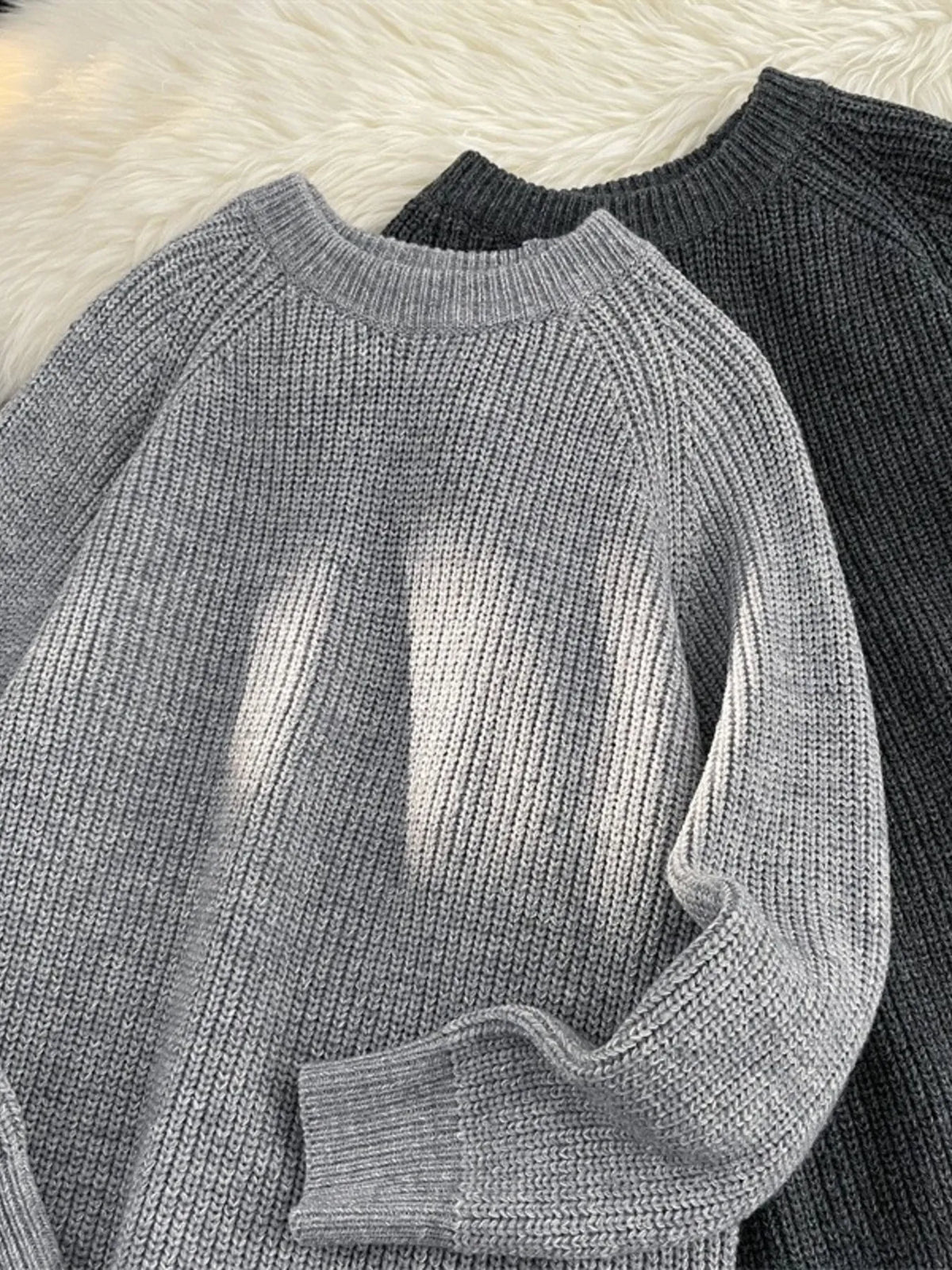 Light gray knit round-neck sweater, long sleeve with ribbed cuff and hem detail
