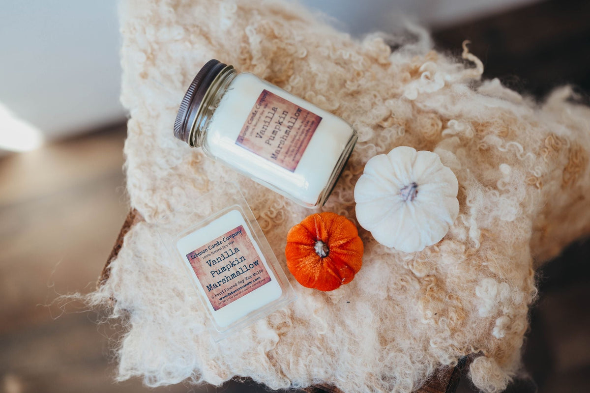 Jar candles in cream plush with white and orange decorative flowers