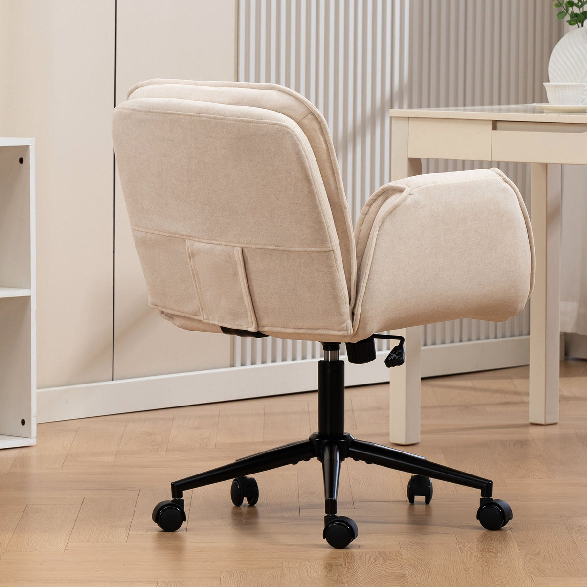 Beige faux leather swivel desk chair with padded high back and armrests
