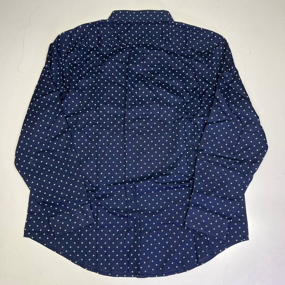 Men's navy button-up shirt back with white daisy pattern, full-length yoke.