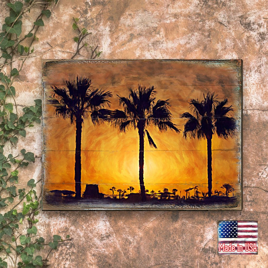 Palm tree sunset wall art with framed panel and dark palm silhouettes over orange sky