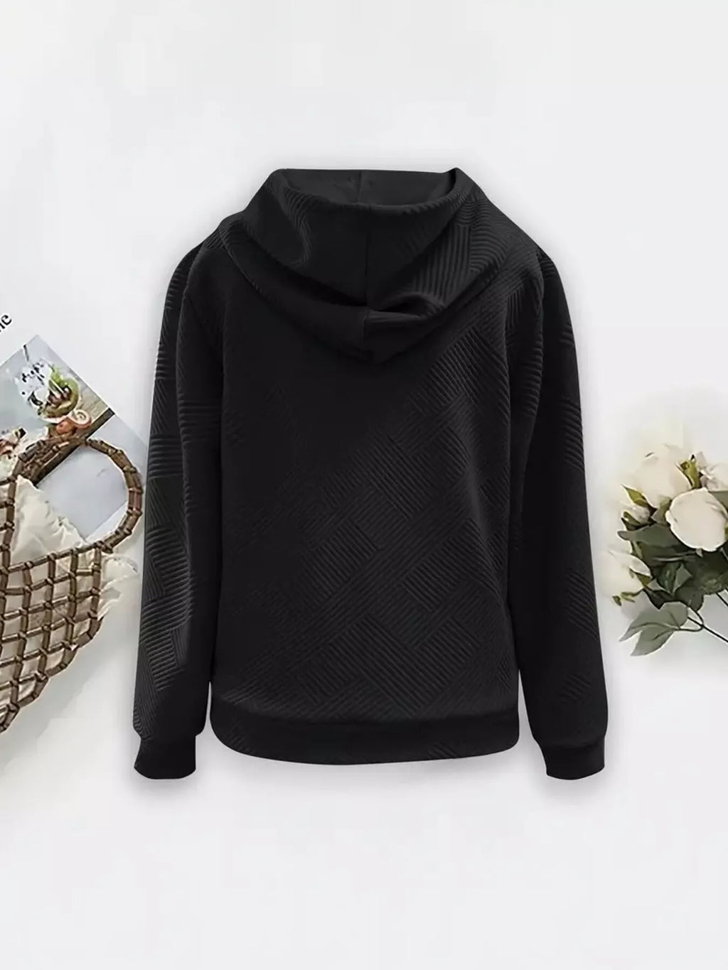 Black zip-up hooded jacket with textured diagonal pattern and front zipper