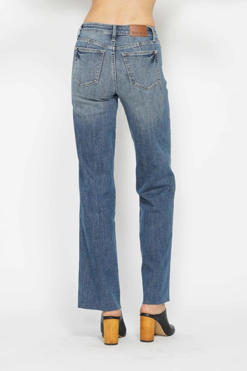 Medium-wash straight-leg jeans, back closeup with yoke seams and patch pockets