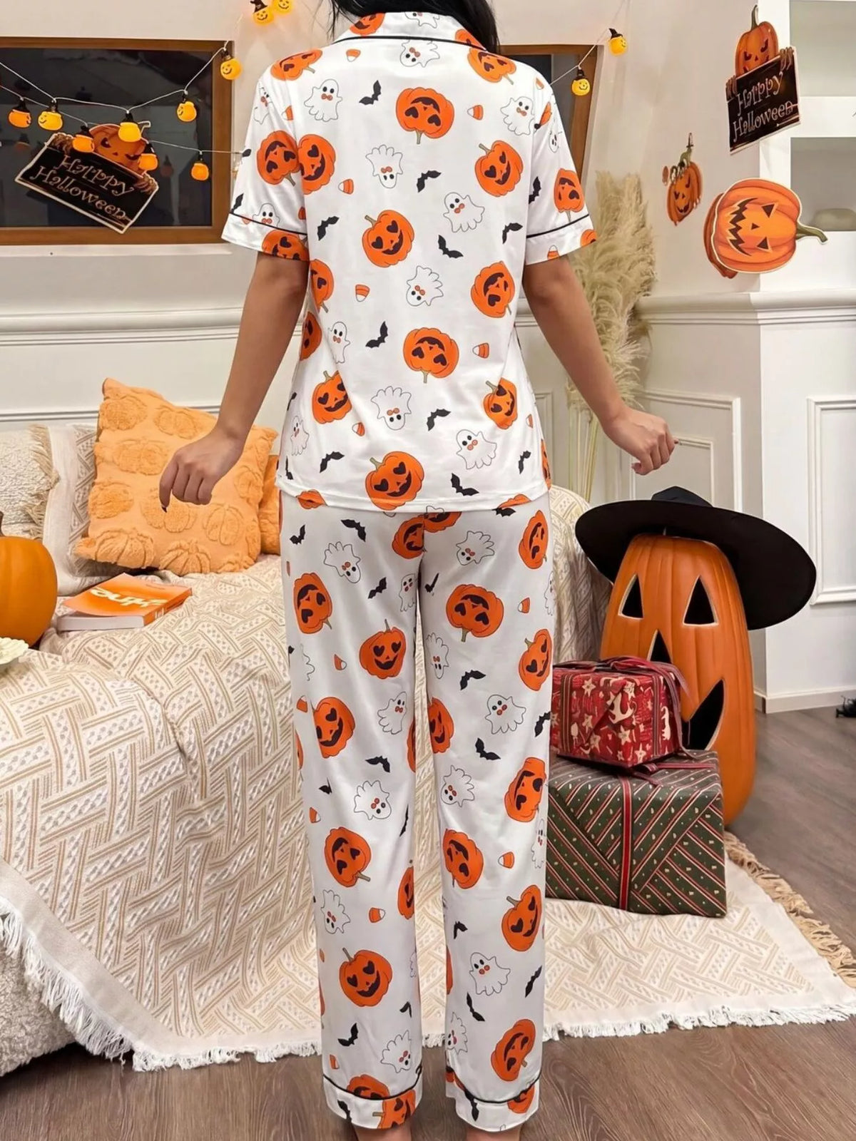 White button-down pajama set with pumpkin-face and ghost prints, short sleeves and ankle-length pants