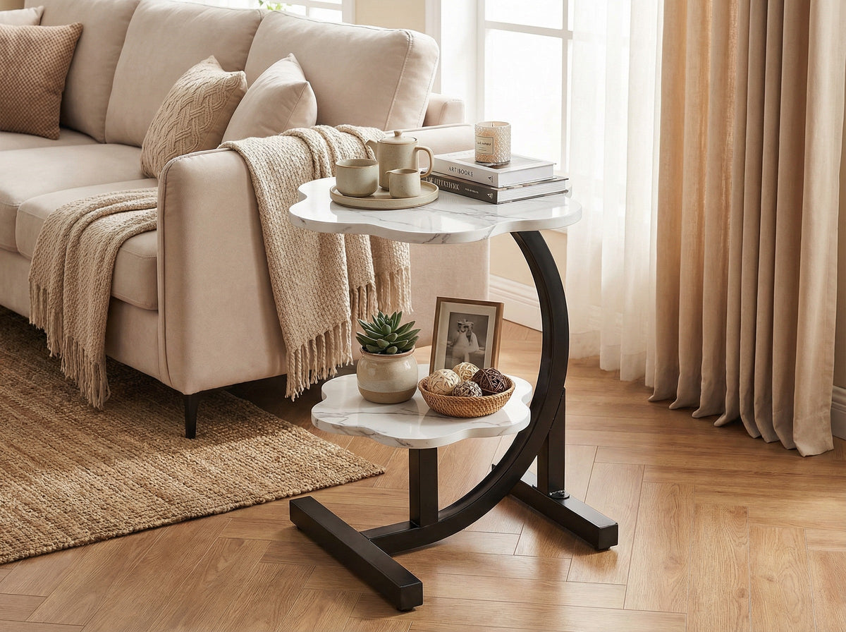 White round side table with two shelves and curved black metal base.